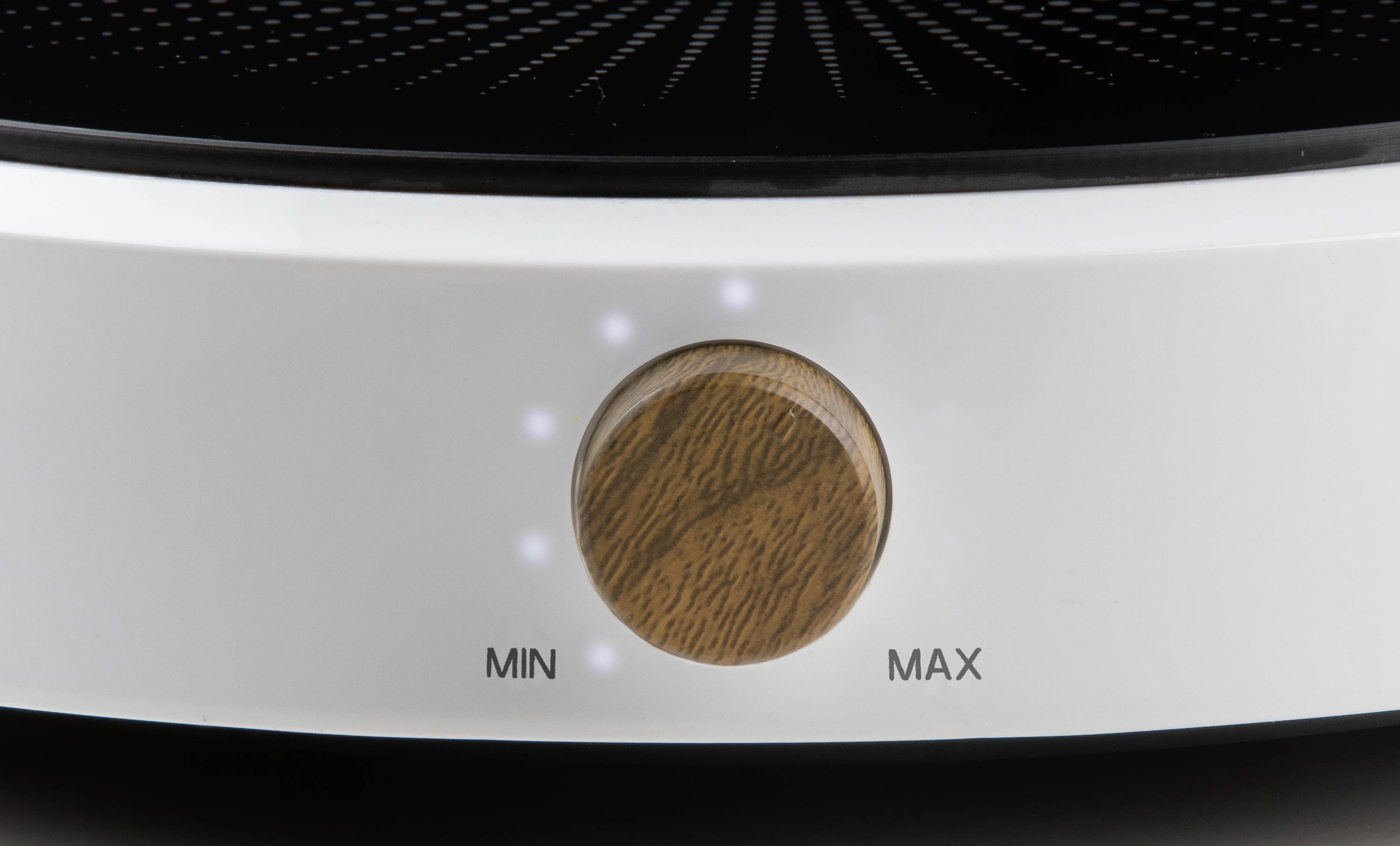 Gros plan d'un appareil électronique blanc avec un bouton rotatif en bois au centre, entouré de marquages de valeurs minimales et maximales.