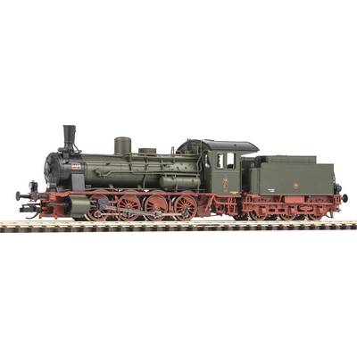Un modèle d'une locomotive à vapeur historique, vert-noir avec des roues rouges, sur une voie ferrée. Représentation détaillée des éléments de la locomotive.