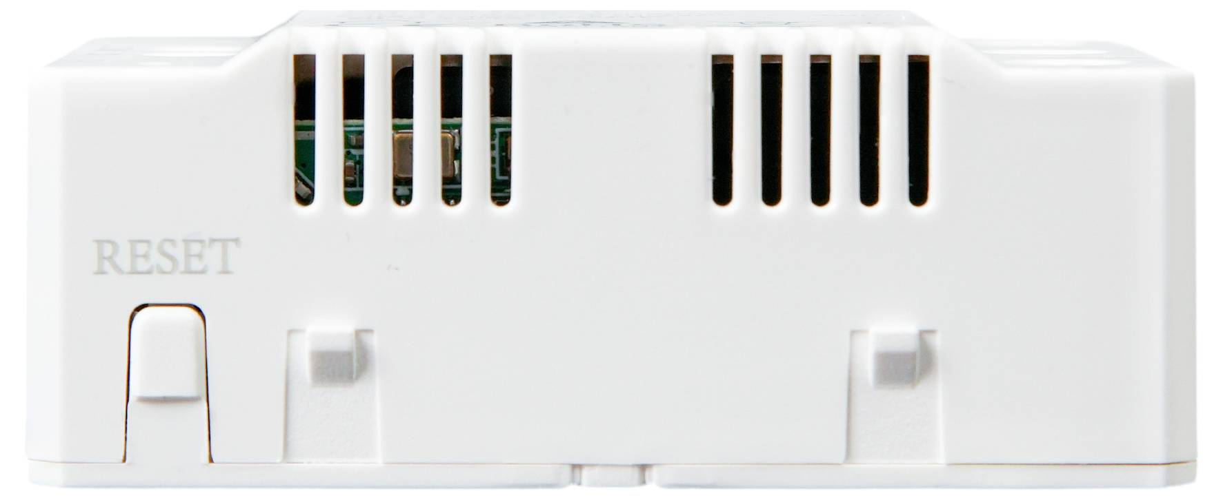 Appareil électronique blanc avec des fentes de ventilation et portant l'inscription 'RESET'. Probablement un capteur ou un dispositif de commande.
