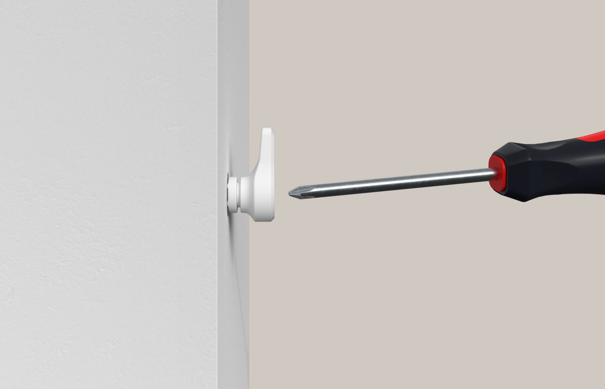 Un tournevis tourne une cheville murale blanche en plastique ou un système de fixation à vis dans un mur.