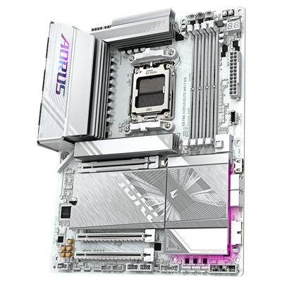 Une carte mère argentée avec plusieurs emplacements mémoire, des slots PCIe, un socket CPU et un logo lumineux ; marque 'AORUS'.