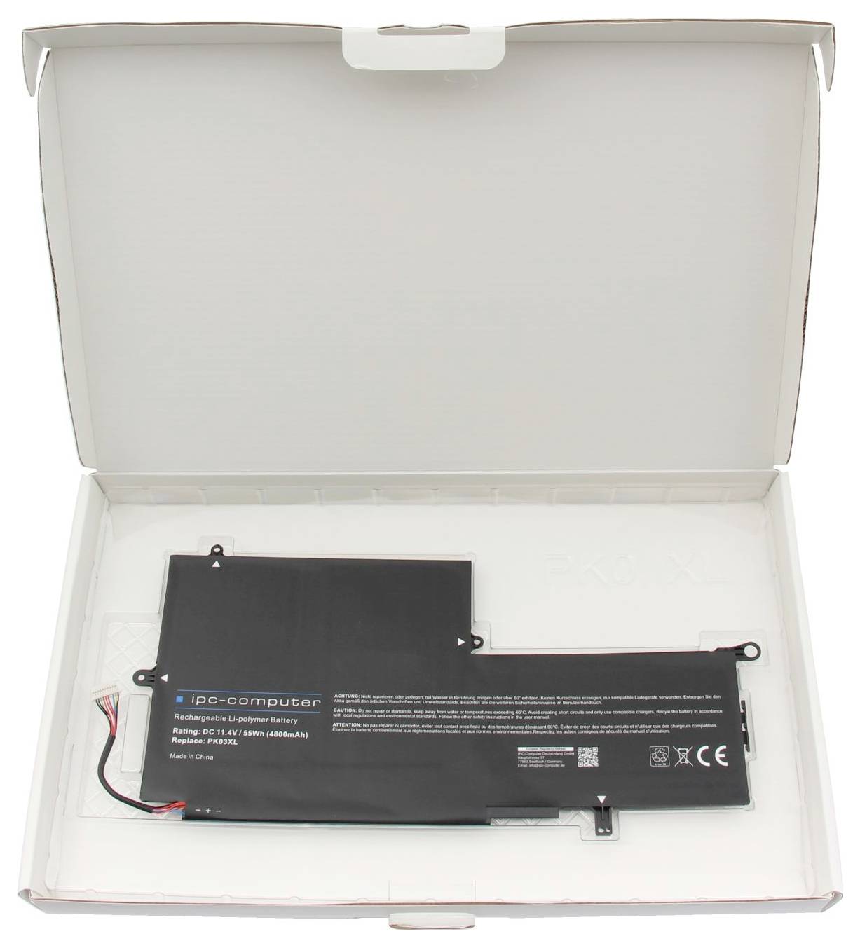 Une boîte ouverte révèle une batterie d'ordinateur portable rectangulaire noire avec des câbles et un marquage technique.