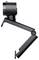 Photo en noir et blanc d'une webcam avec un support réglable. La caméra est montée sur une surface métallique et présente un design moderne.