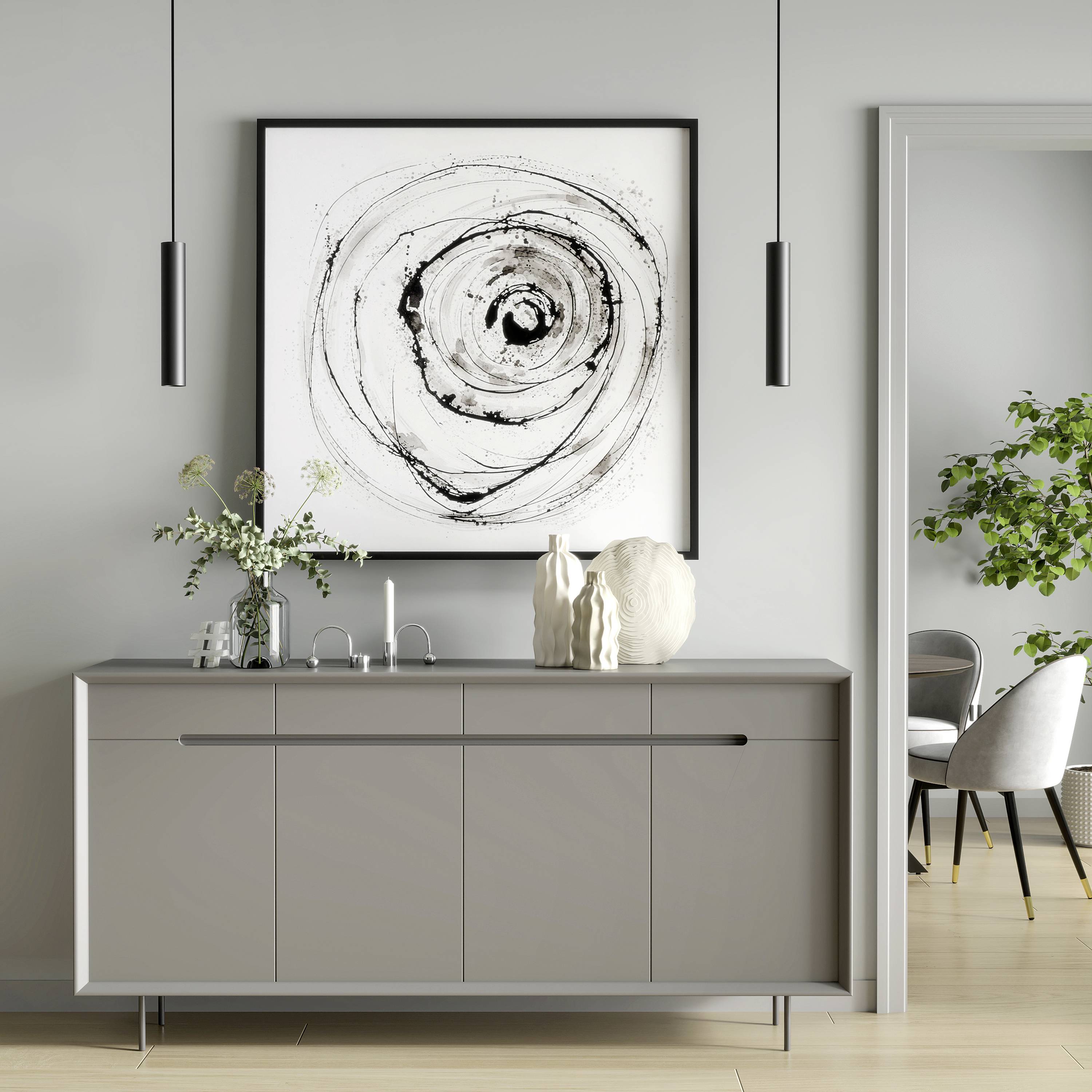 Un salon moderne avec un buffet gris sur lequel sont posés des vases. Un tableau abstrait et circulaire est accroché au mur. À gauche se trouve une plante.