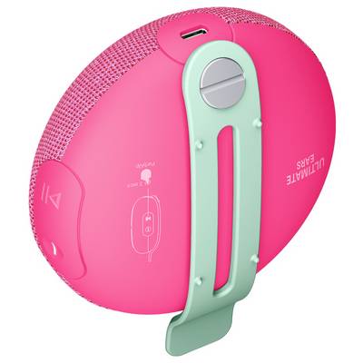 Un haut-parleur Bluetooth portable rose, équipé d'un clip de fixation vert et de touches de commande sur le côté. Un port USB est visible sur le dessus.