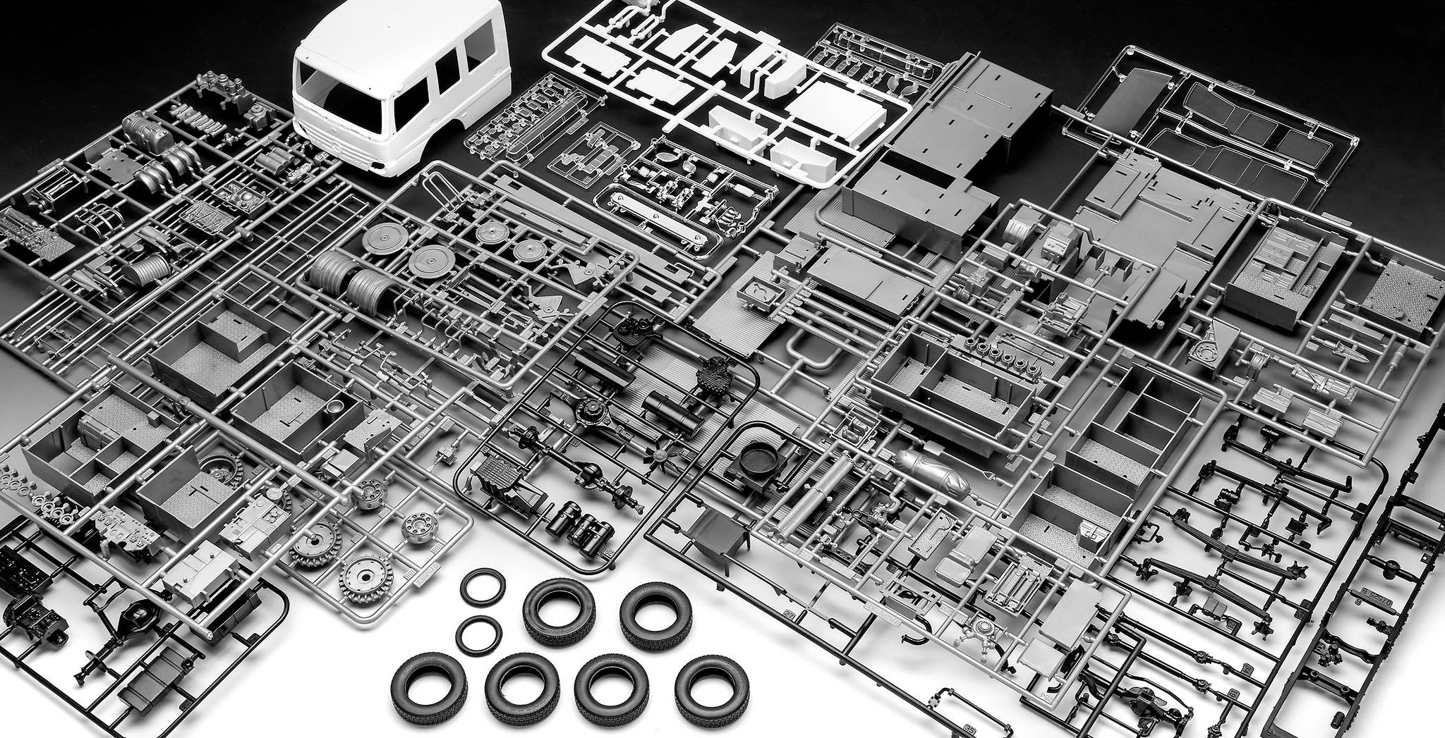 Une maquette de bus, composée de nombreuses petites pièces soigneusement organisées sur une table.