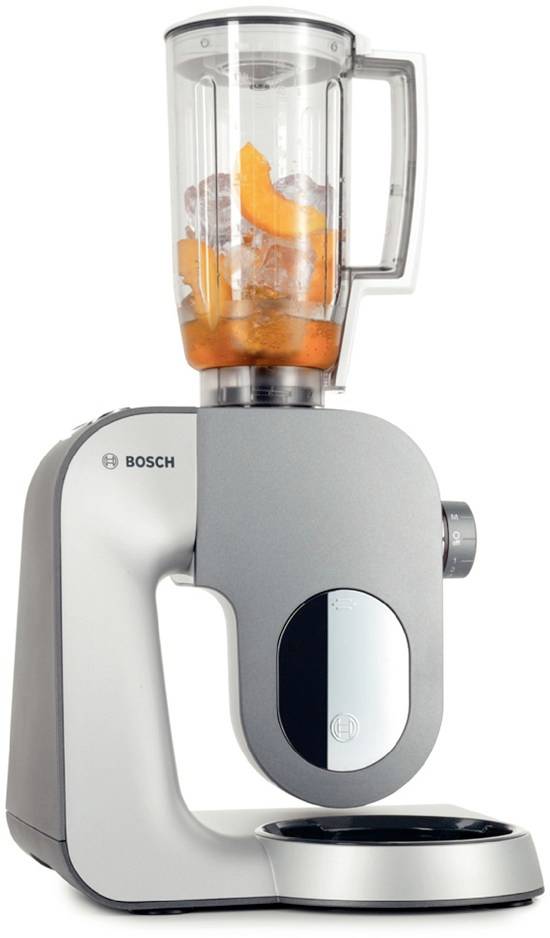 Un mixeur Bosch avec un boîtier gris et un récipient transparent, rempli de glaçons et de tranches d'orange.