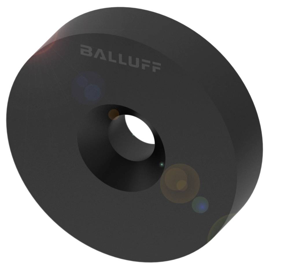 Capteur d'induction rond noir de Balluff avec un petit trou au centre, surface légèrement réfléchissante.
