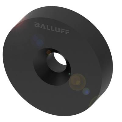 Capteur d'induction rond noir de Balluff avec un petit trou au centre, surface légèrement réfléchissante.