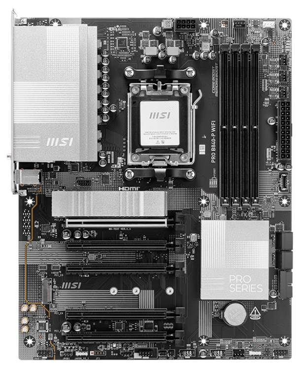 Carte mère noire avec dissipateurs thermiques argentés et slots PCIe. Inscription 'PRO SERIES'. Emplacements pour RAM et CPU visibles.
