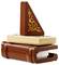 Une pile de livres LEGO avec une plume marron et une pièce triangulaire ornementée sur le dessus, évoquant une configuration de bureau.