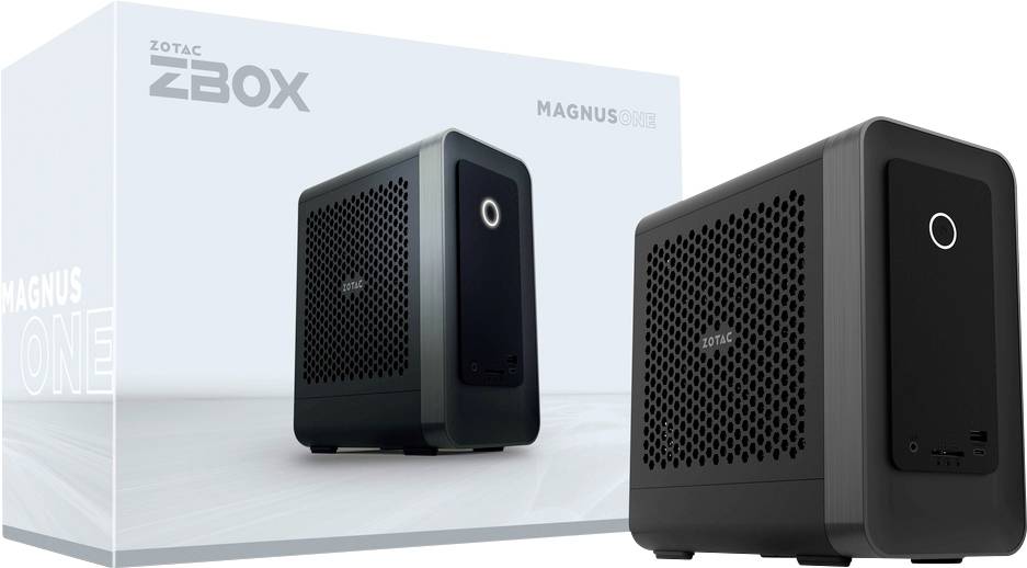 Un mini PC compact noir Zotac ZBOX Magnus est présenté à côté de sa boîte. La boîte présente le logo ZBOX et le nom du produit.