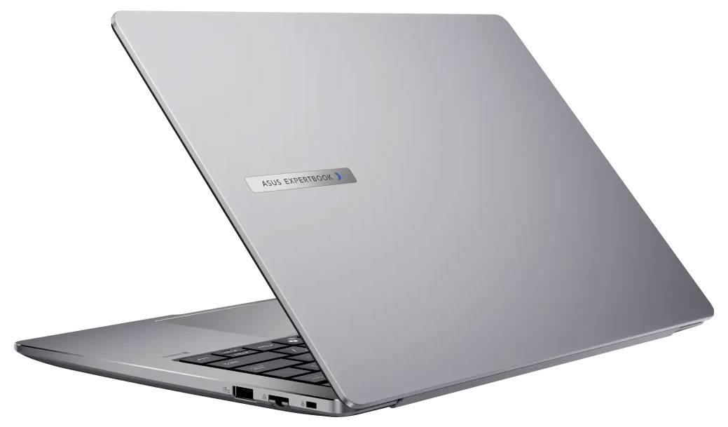 Un ordinateur portable élégant, argenté, partiellement ouvert, montrant des ports USB sur le côté et un clavier. Le couvercle est marqué du logo 'ASUS ZenBook'.