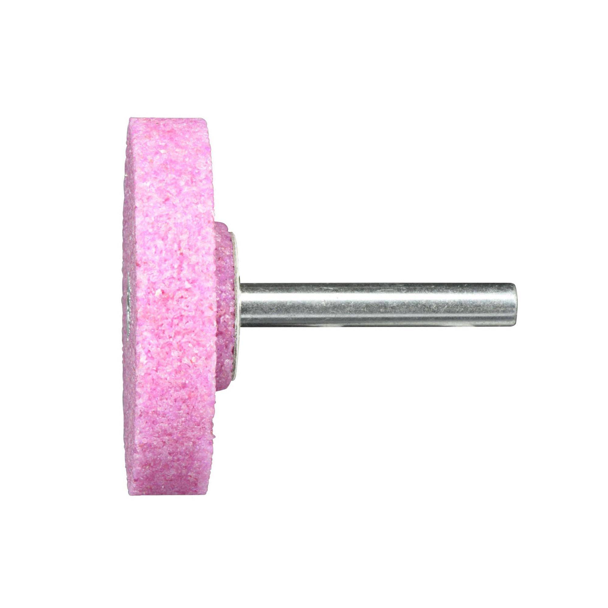 Une roue abrasive rose avec une tige métallique, utilisée comme outil de meulage monté pour des travaux de détail en métallerie et en menuiserie.