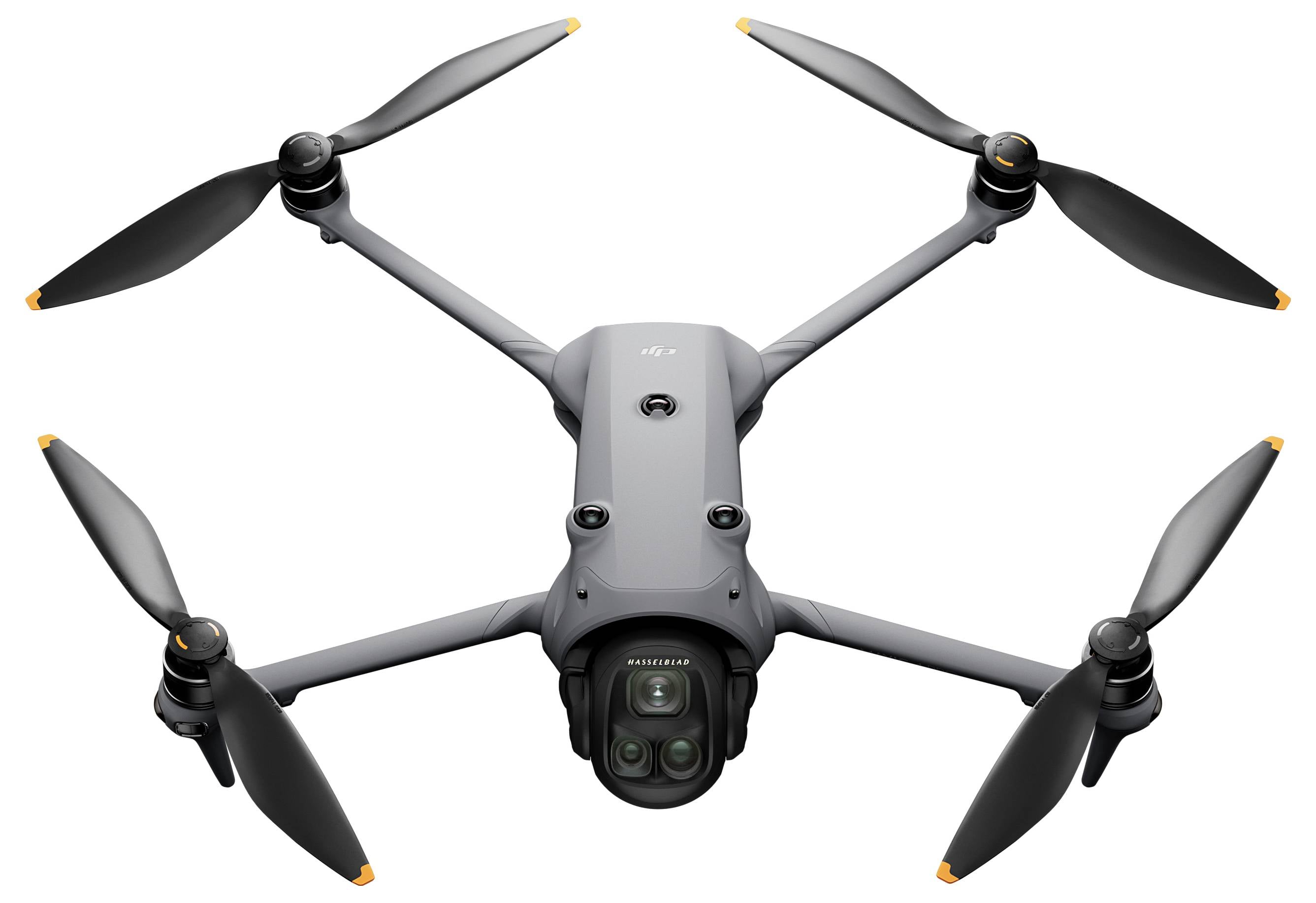 Un drone gris à quatre hélices, équipé d'une caméra, est présenté vue du dessus.