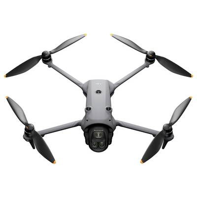Un drone gris à quatre hélices, équipé d'une caméra, est présenté vue du dessus.
