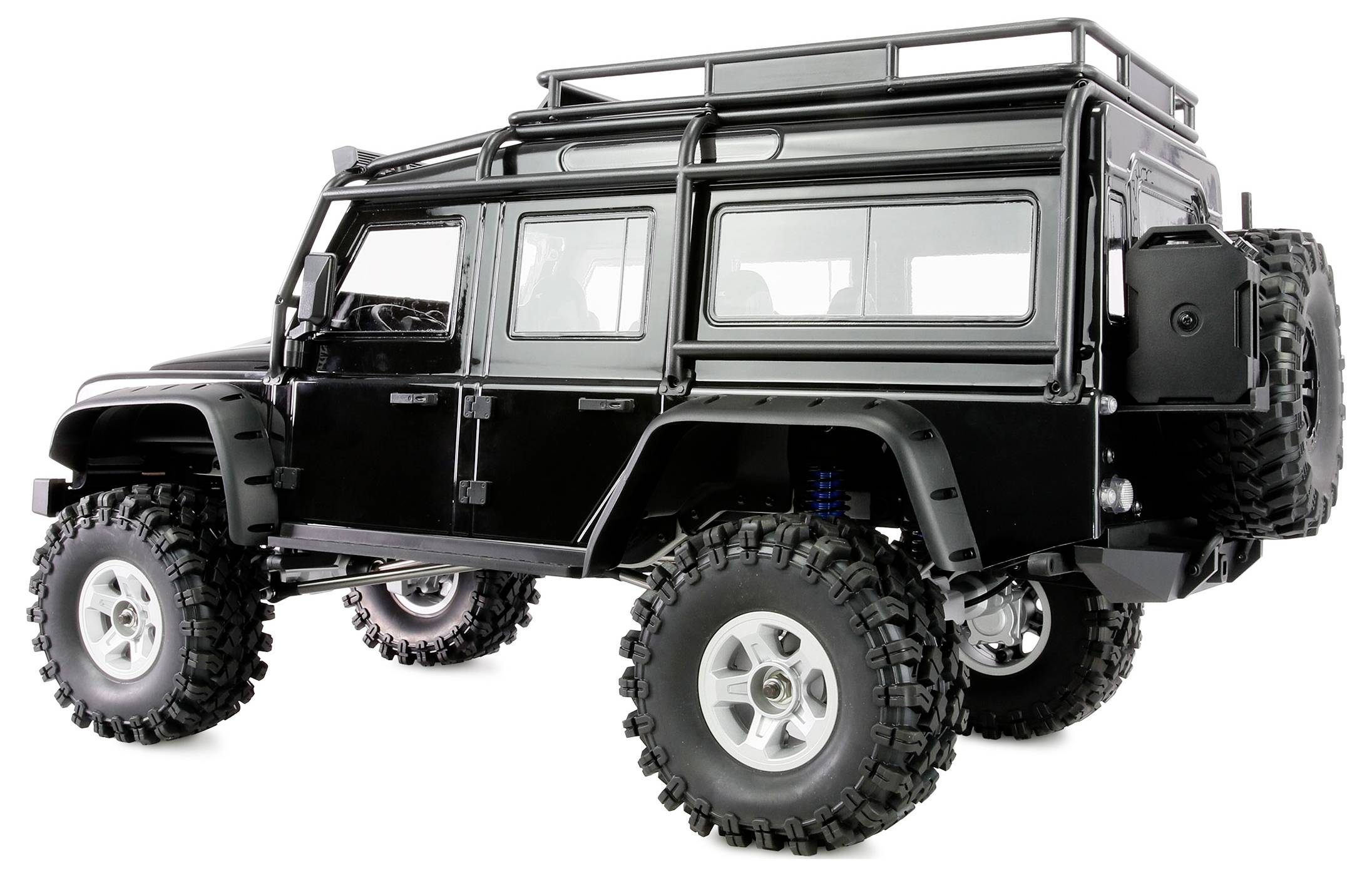 Un véhicule tout-terrain noir avec des pneus robustes et un porte-bagages de toit, vu de profil, mettant en valeur sa conception solide et son grand dégagement au sol.