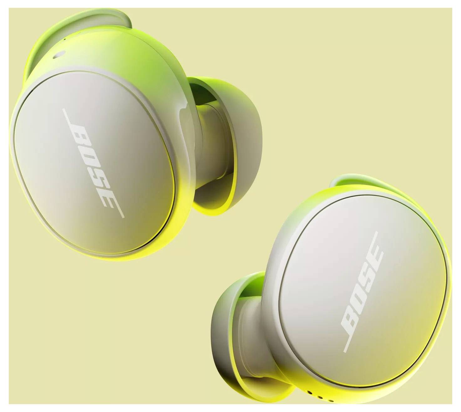 Écouteurs sans fil Bose jaunes et gris sur un fond beige, mettant en valeur un design élégant.