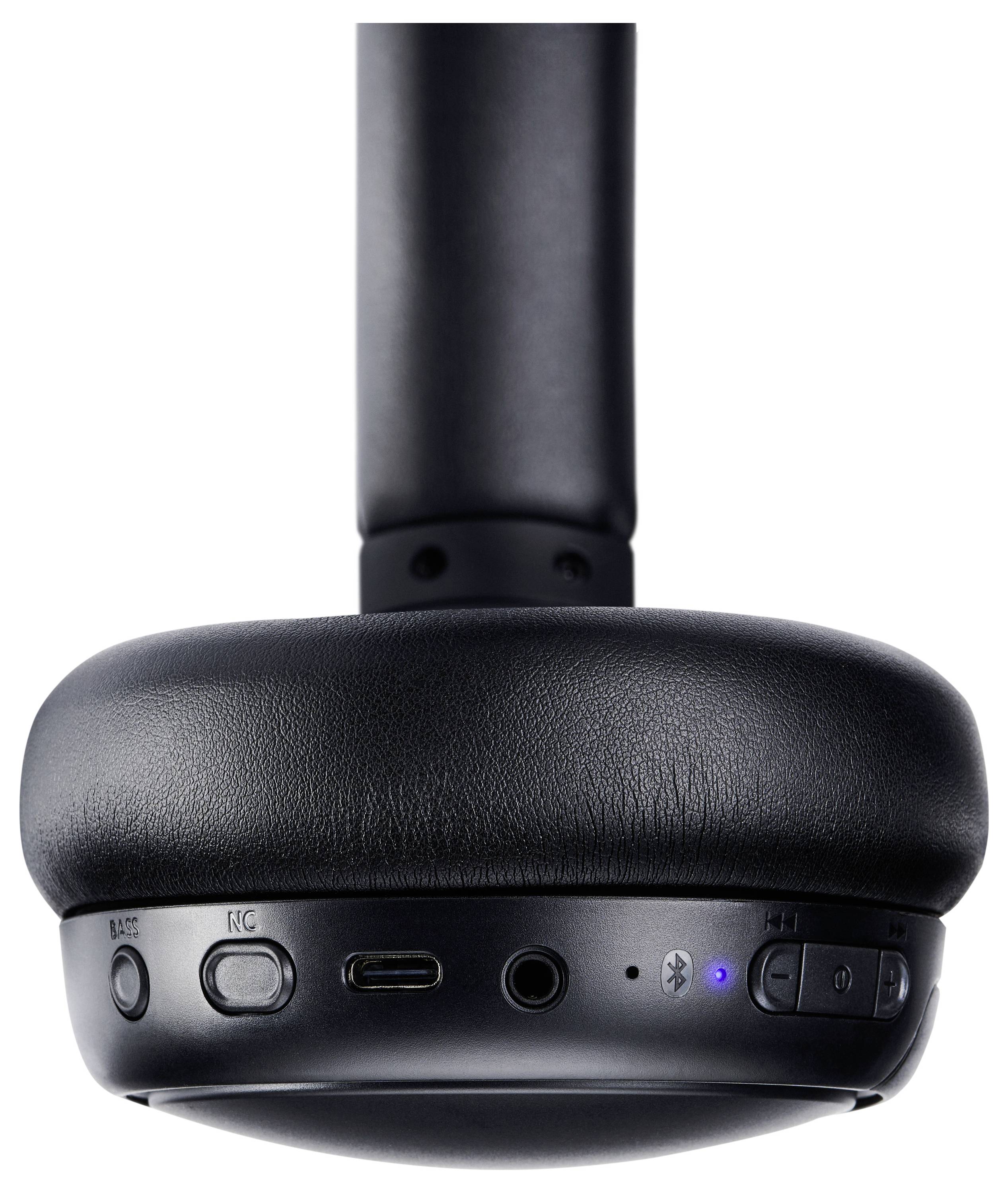 Écouteurs sans fil noirs présentant la face inférieure du casque avec boutons de commande et ports, comprenant l'alimentation, l'USB-C et la connectivité Bluetooth.