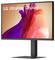 Écran LG UltraFine affichant des formes fluides abstraites en rouge et violet, mettant en valeur les capacités de couleurs vives du moniteur.