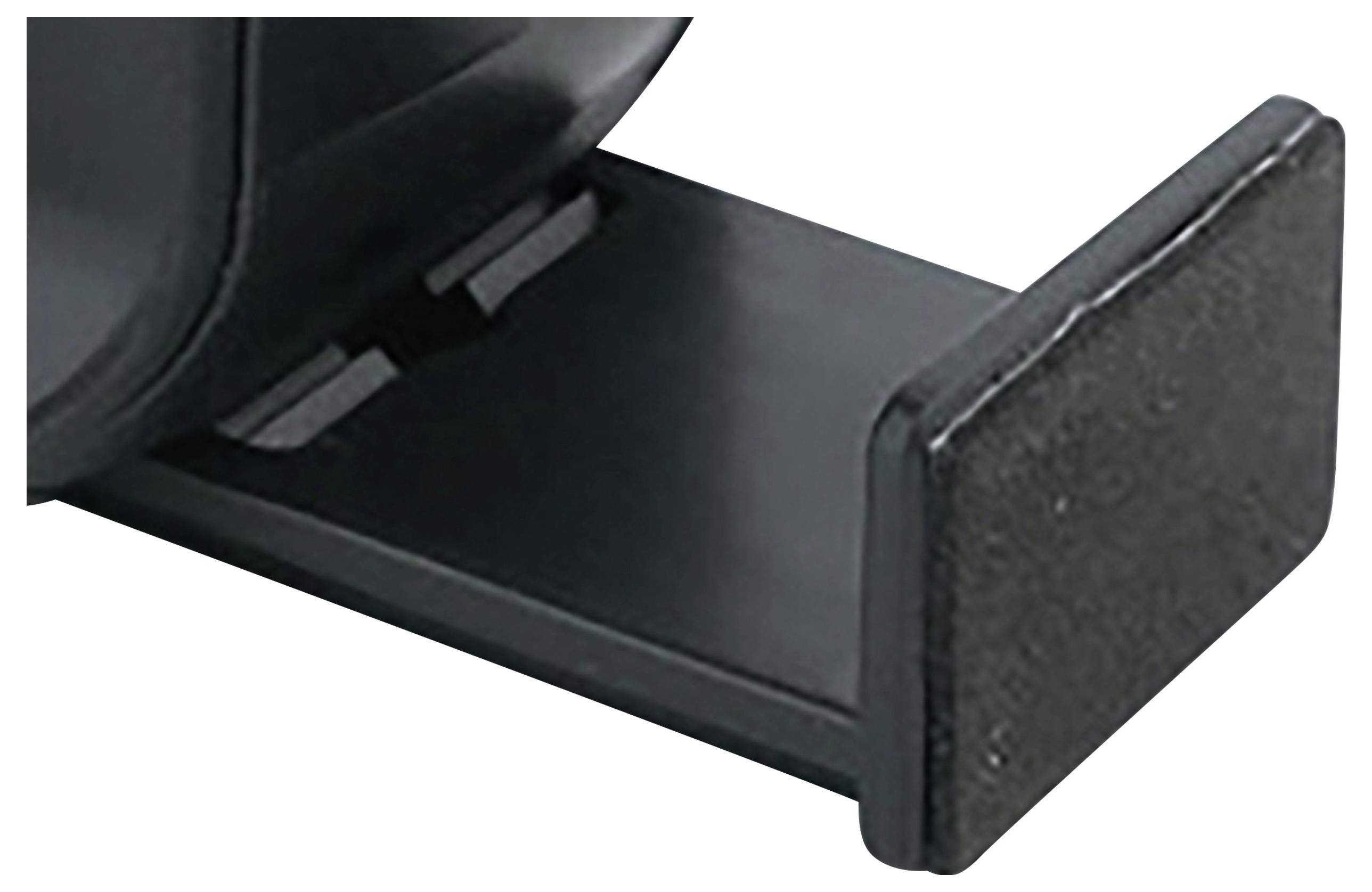 Gros plan d'un support ou d'un support de fixation en plastique noir ou en métal, avec une base plate, probablement un élément d'un appareil ou d'un dispositif plus grand.