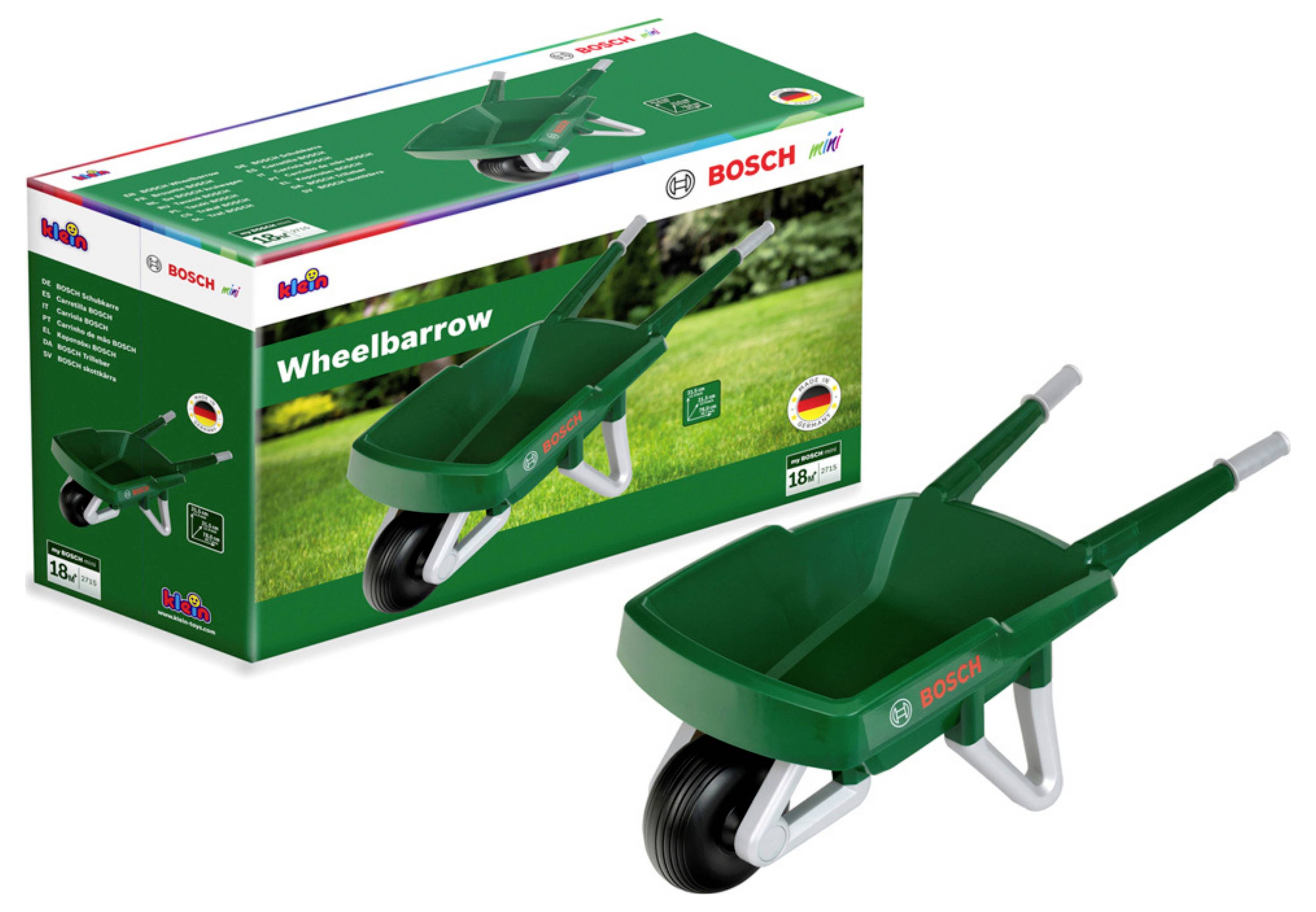 Brouette jouet verte avec logo 'Bosch' sur la boîte et le tonneau, conçue pour les enfants de 18 mois et plus. Emballage sur un fond d'herbe.