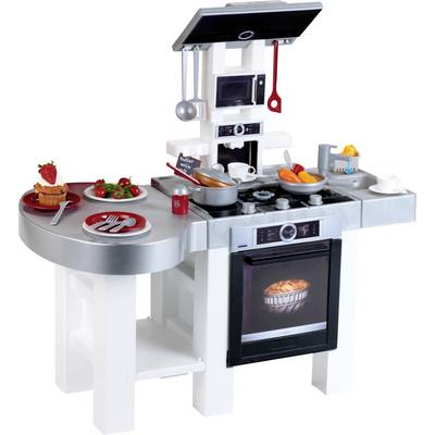 Cuisine jouet avec cuisinière, four et ustensiles. Comprend une scène de cuisine simulée avec des aliments factices et des ustensiles de cuisine sur le plan de travail.