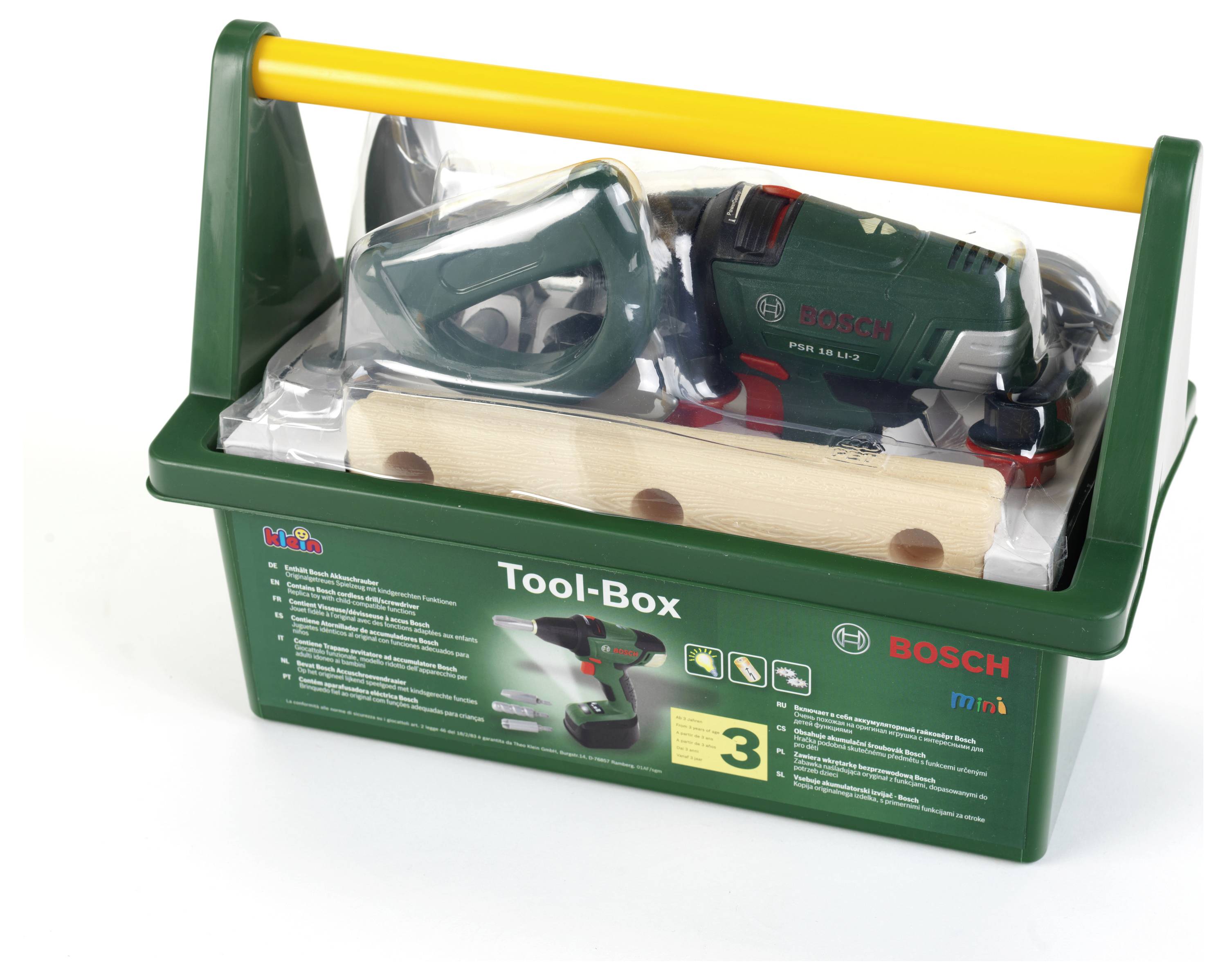 Boîte à outils en plastique vert avec une perceuse, une scie et un marteau. Couvercle transparent, poignée jaune, étiquetée 'Boîte à outils', logo de la marque visible.