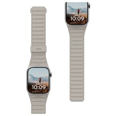 Montre connectée avec bracelet beige, affichant un paysage montagneux et un randonneur sur l'écran, avec l'heure '10:09' et le jour 'Lun 5'.
