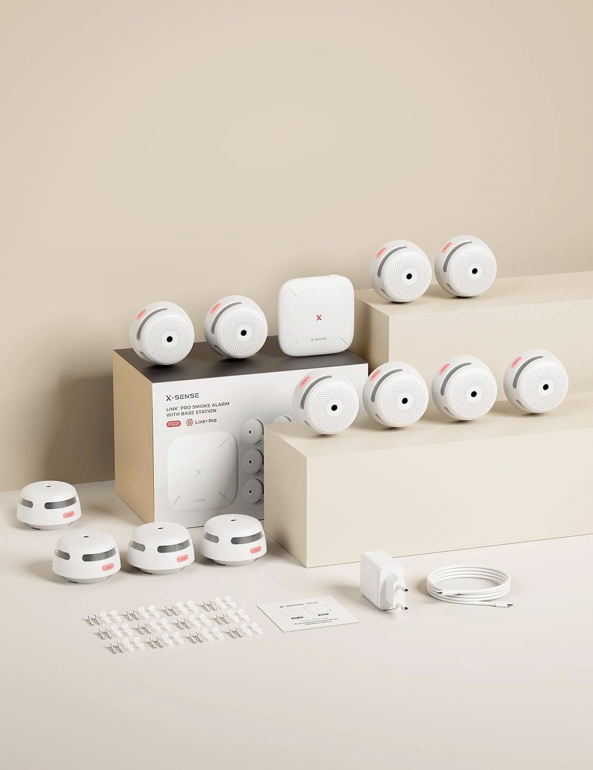 Kit de détecteur de fumée et de monoxyde de carbone X-Sense comprenant 10 détecteurs, une unité de contrôle, un chargeur, un câble et un manuel d'utilisation en exposition.