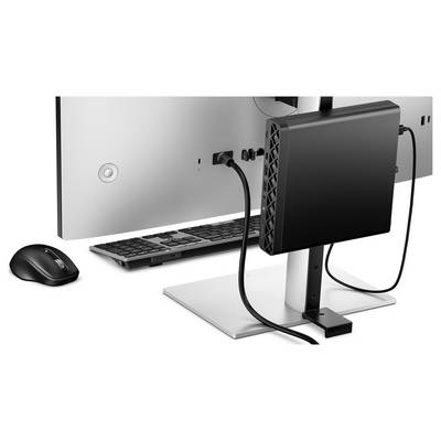 Un écran d'ordinateur avec un client léger et divers câbles connectés à l'arrière, à côté d'un clavier et d'une souris sans fil sur un bureau.