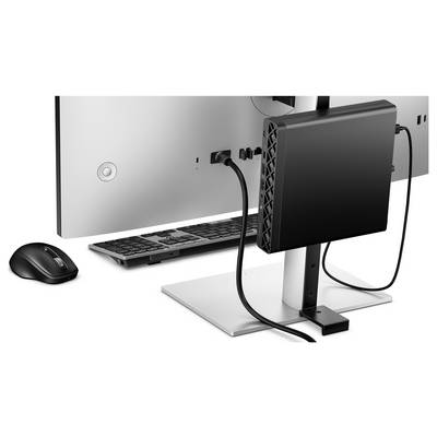 Un écran d'ordinateur avec un clavier et une souris sans fil, montrant un fin boîtier noir fixé à l'arrière, relié par un câble.