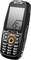 Un téléphone mobile robuste de couleur noire, équipé d'un clavier, de touches larges et d'un petit écran affichant un symbole 'Ex', indiquant une conception protégée pour les environnements à risques.