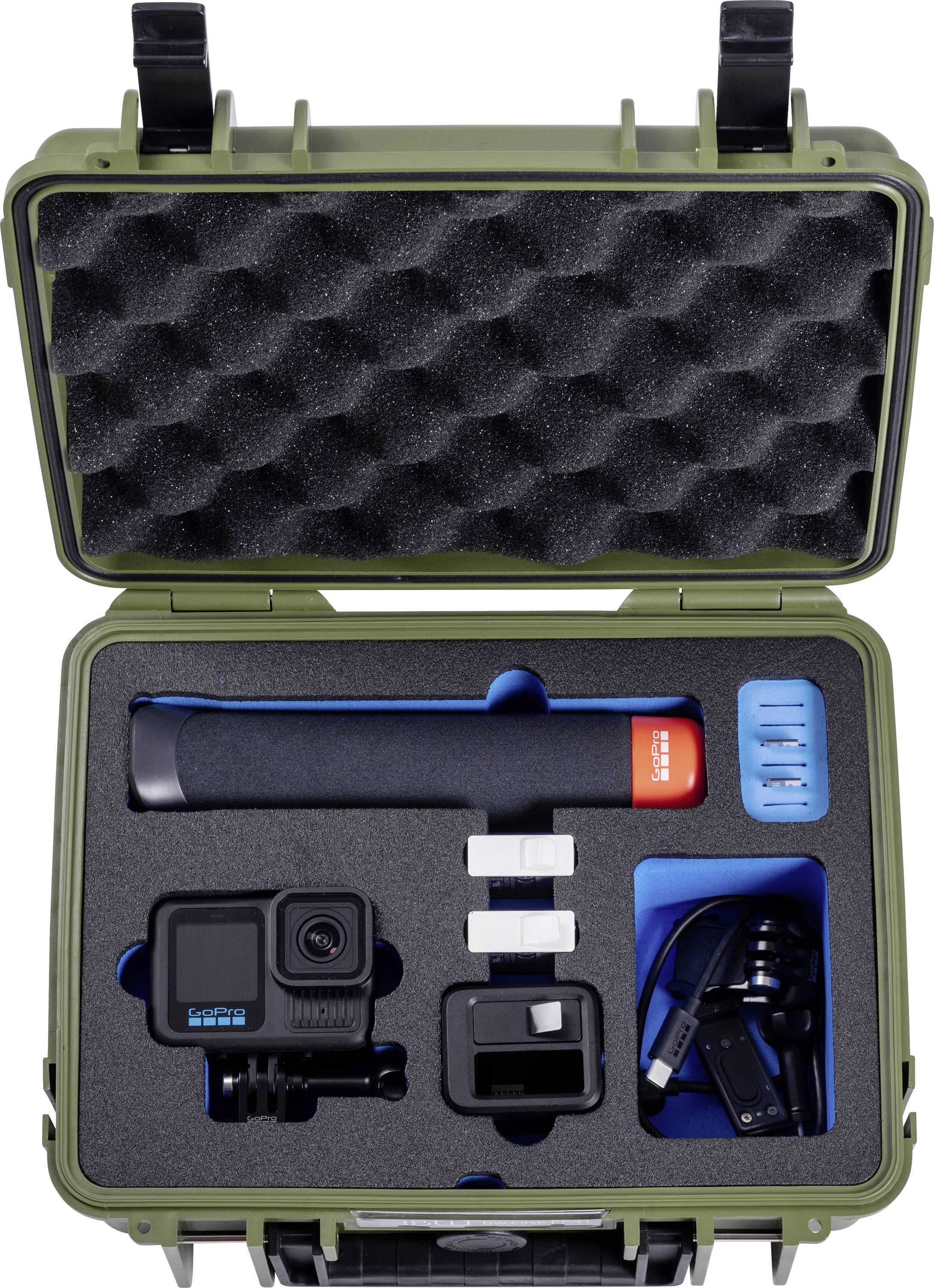 Un étui vert ouvert avec un insert en mousse, contenant une caméra d'action, une poignée, trois batteries et des câbles USB, soigneusement rangés pour le rangement.