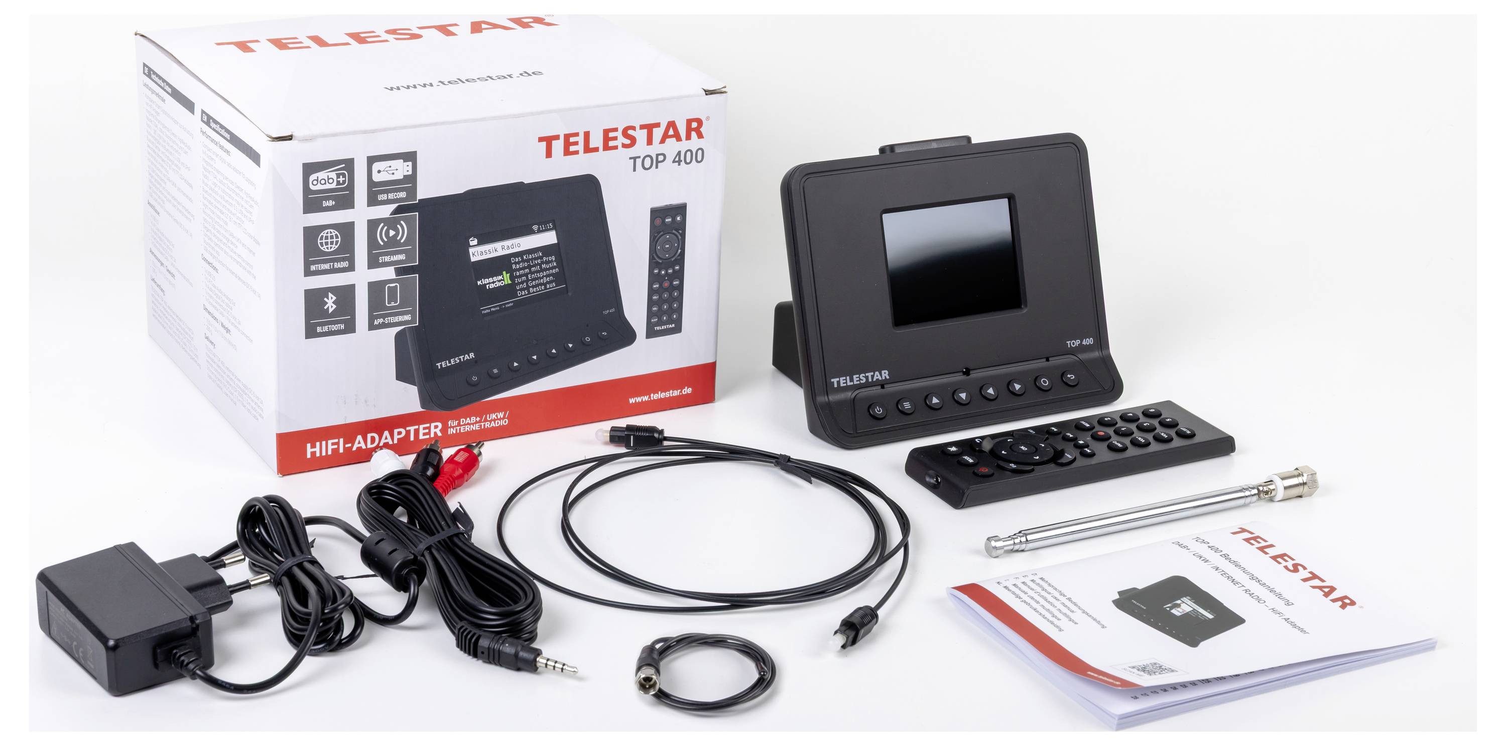 Boîte et contenu de l'adaptateur Hi-Fi 'Telestar Top 400', comprenant une unité d'affichage, une télécommande, des câbles, une antenne, un manuel et un adaptateur secteur.