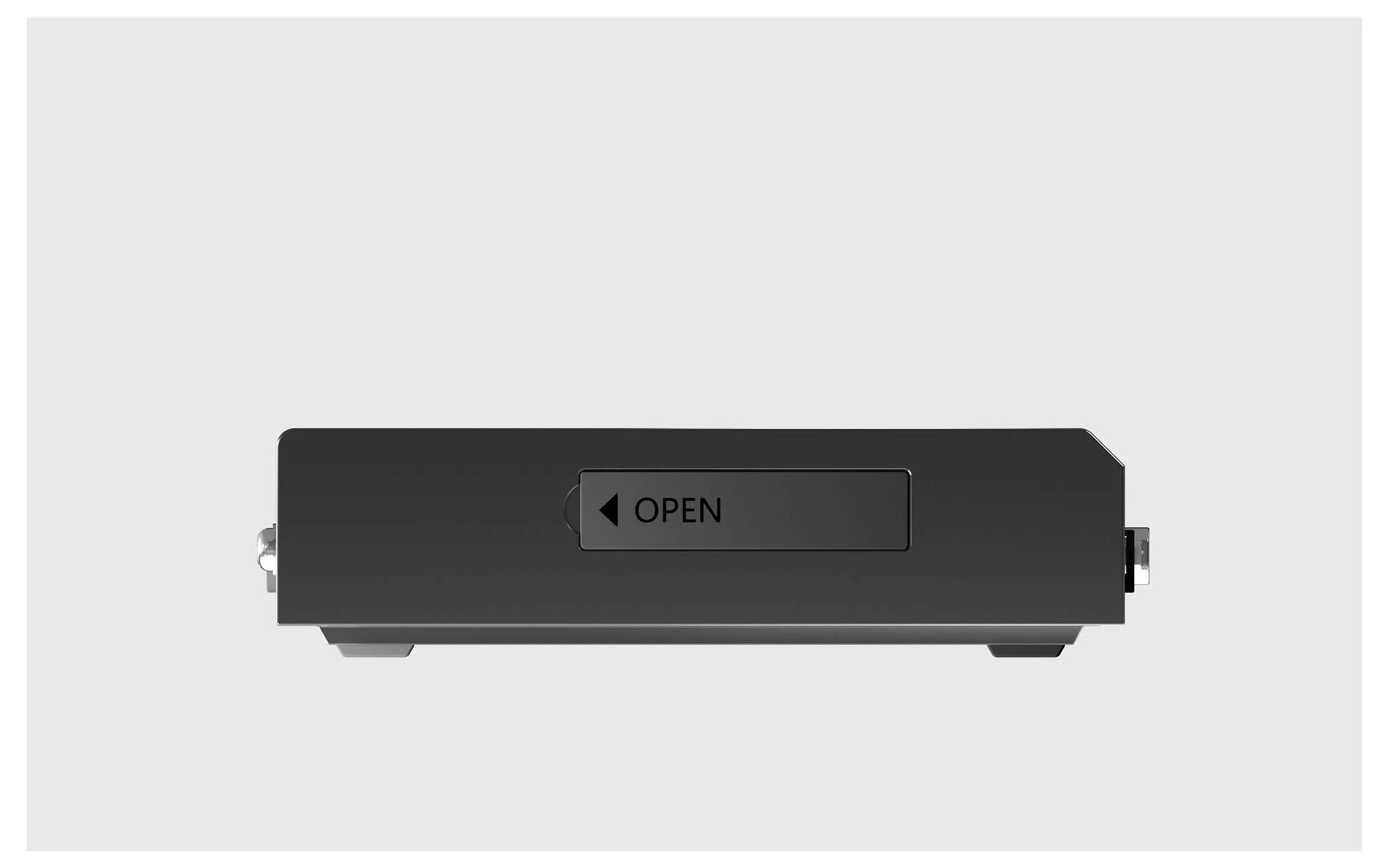 Un boîtier de disque dur noir vu de dessus, présentant un bouton étiqueté « OPEN » au centre, sur un fond uni.