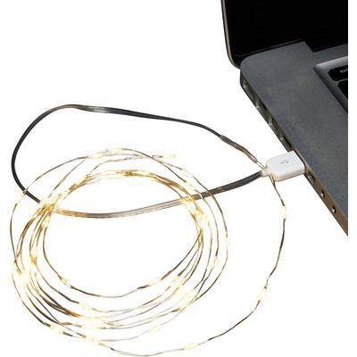Un cordon de petites lumières LED enroulé, relié à un ordinateur portable par USB, luisant doucement à côté du clavier de l'ordinateur portable.