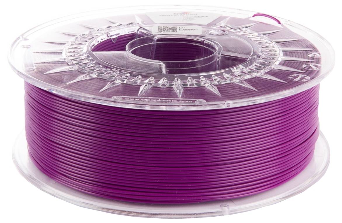 Un bobineau de filament d'imprimante 3D violet sur une bobine transparente en plastique, enroulé uniformément, utilisé pour créer des objets imprimés en 3D.