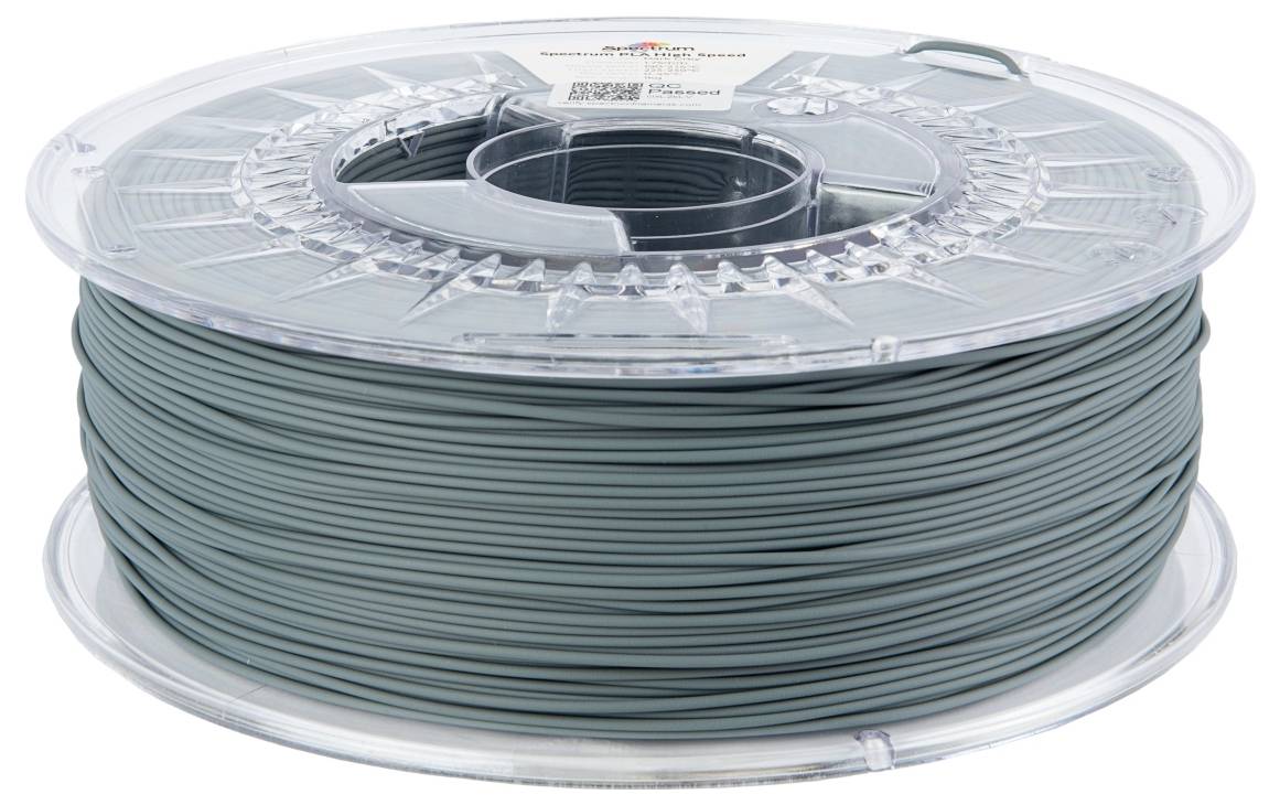 Une bobine de filament vert foncé pour impression 3D, enfermée dans un boîtier en plastique transparent.