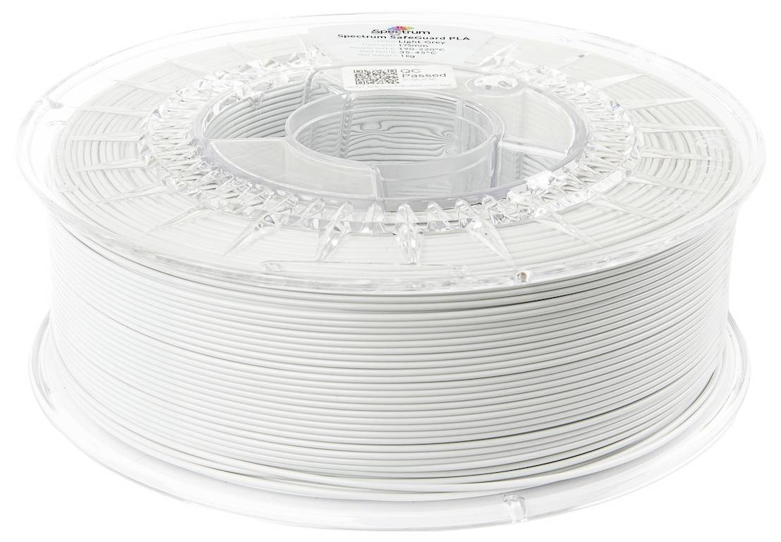 Bobine de filament d'impression 3D blanc sur un dévidoir en plastique transparent, étiquetée 'Spectrum Filaments', pesant 1 kilogramme.