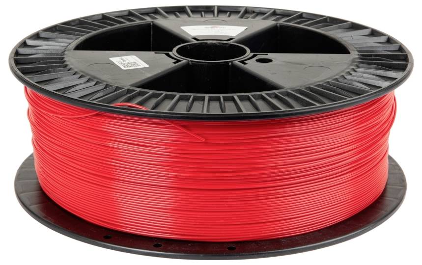 Bobine de filament d'imprimante 3D rouge avec un centre noir, reposant horizontalement.