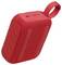 'Enceinte Bluetooth portable rouge avec surface texturée et boucle attachée pour le transport.'