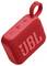 Enceinte portable rouge avec texture en tissu, montrant le logo de la marque et les boutons de commande sur le dessus.
