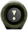 Un objet en caoutchouc vert et noir avec un bouton central présentant un point d'exclamation et un point, probablement un dispositif interactif ou de contrôle.