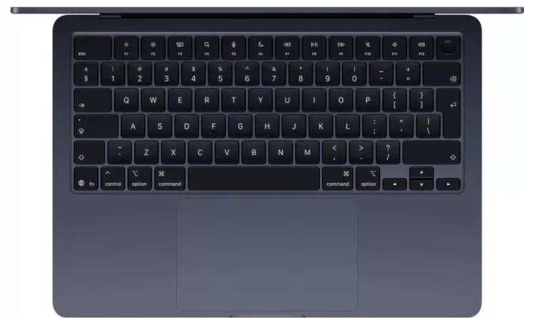 Clavier d'ordinateur portable et pavé tactile, vue de dessus. Comprend une disposition QWERTY standard avec des touches noires sur un fond sombre, bouton d'alimentation situé en haut à droite.