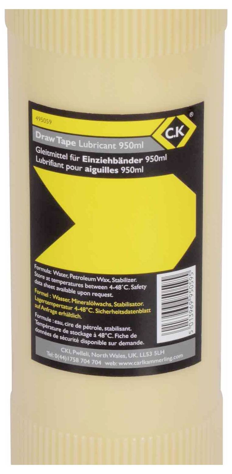 Un conteneur beige étiqueté 'Draw Tape Lubricant 950ml', avec du texte multilingue et une grande flèche jaune sur une section noire.