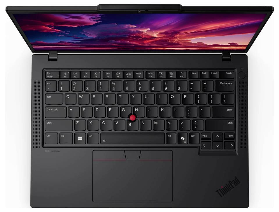 Un ordinateur portable noir vu de dessus, avec un clavier rétroéclairé et un point rouge au milieu. Un coucher de soleil coloré est visible en arrière-plan sur l'écran.