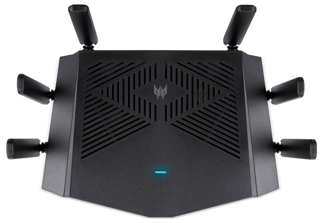 Un routeur sans fil noir et anguleux avec six antennes, présentant un indicateur lumineux et un design géométrique sur la surface supérieure.