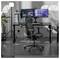 Une chaise de gaming dans un setup moderne avec deux écrans sur un bureau, un ordinateur de bureau avec des ventilateurs illuminés, et un anneau lumineux en arrière-plan.