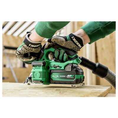 Une personne utilise un outil électrique vert et noir pour poncer du bois, portant des gants de protection. L'outil est étiqueté 'Hikoki 36V 18V MultiVolt'.